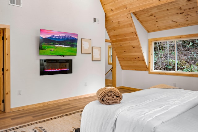 bedroom with lofted ceiling, wooden ceiling, visible vents, and wood finished floors