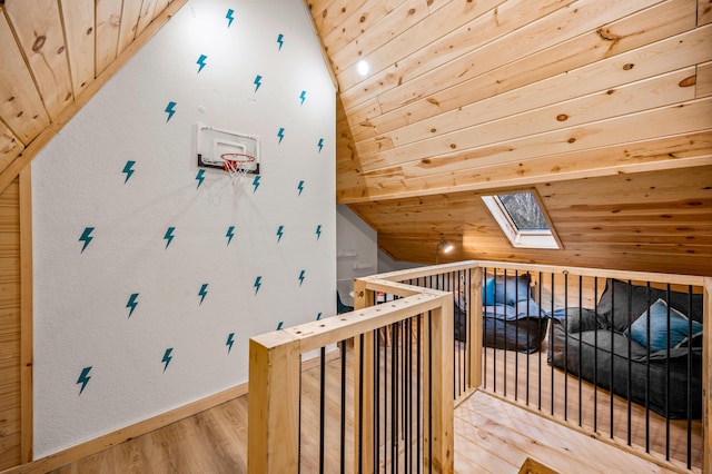 bonus room with baseboards, lofted ceiling with skylight, wooden ceiling, and light wood-style floors