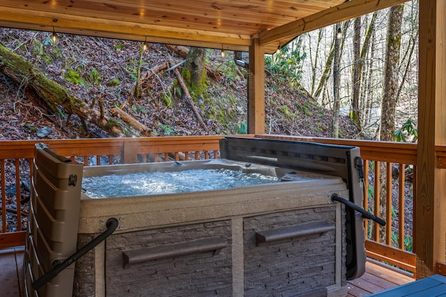 wooden terrace featuring a hot tub