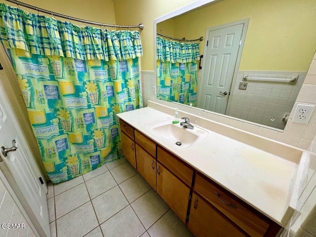 bathroom featuring tile patterned flooring, vanity, and tile walls