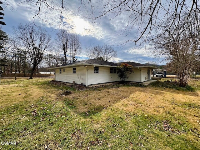 view of side of home featuring a yard