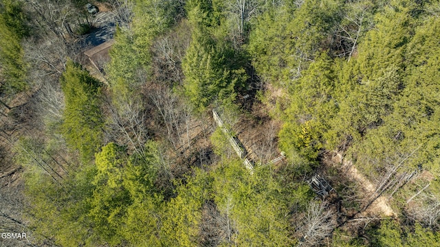 drone / aerial view featuring a forest view