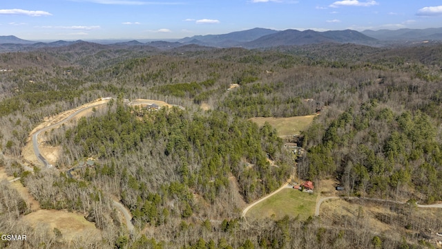 aerial view featuring a mountain view and a view of trees