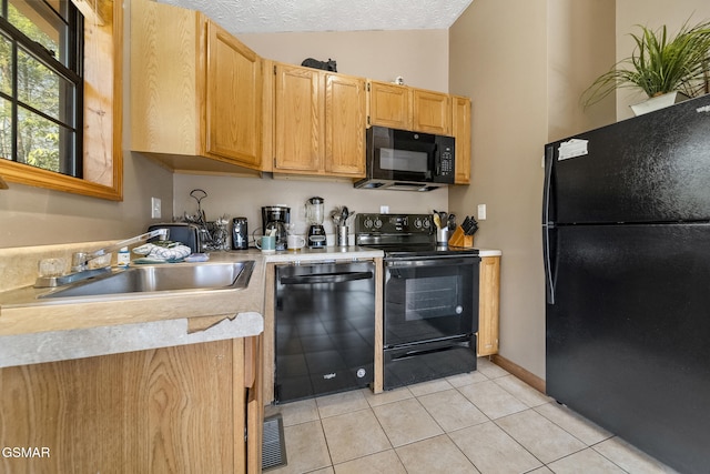 kitchen featuring vaulted ceiling, a textured ceiling, light countertops, black appliances, and a sink