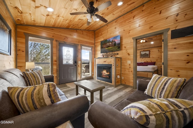 living area featuring lofted ceiling, wood ceiling, and a wealth of natural light