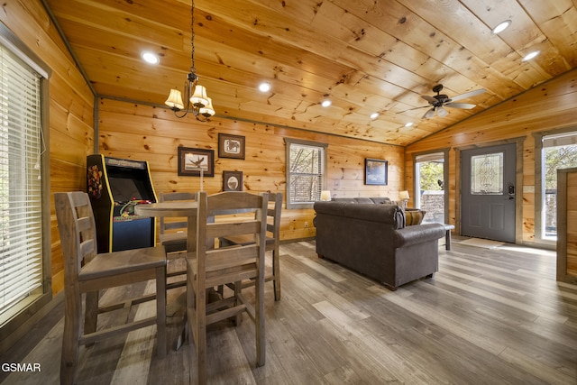 interior space featuring wood ceiling, vaulted ceiling, wood walls, and wood finished floors