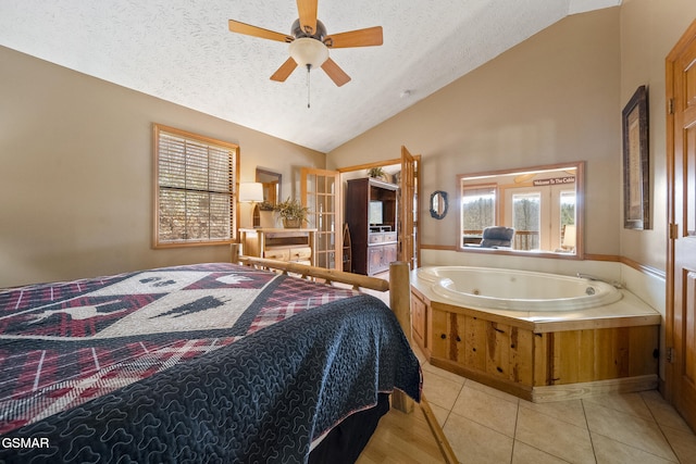 bedroom featuring french doors, a ceiling fan, light tile patterned flooring, vaulted ceiling, and a textured ceiling