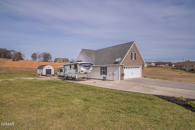 view of front of house featuring a storage unit, a front lawn, and a garage