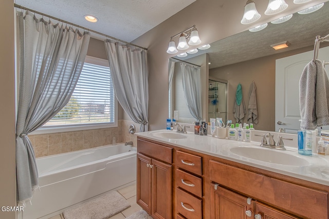 bathroom with tile patterned floors, vanity, a textured ceiling, and independent shower and bath