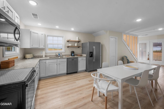 kitchen featuring light hardwood / wood-style flooring, sink, stainless steel appliances, and white cabinets