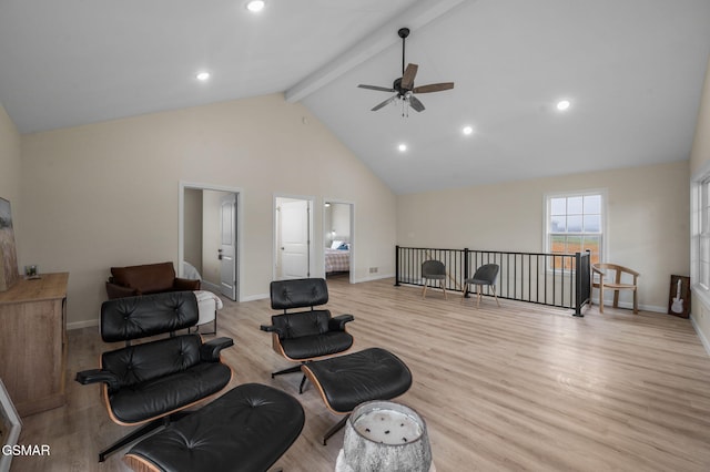 sitting room with ceiling fan, high vaulted ceiling, beamed ceiling, and light hardwood / wood-style floors