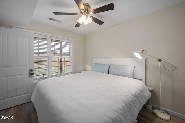 bedroom featuring ceiling fan and dark hardwood / wood-style floors