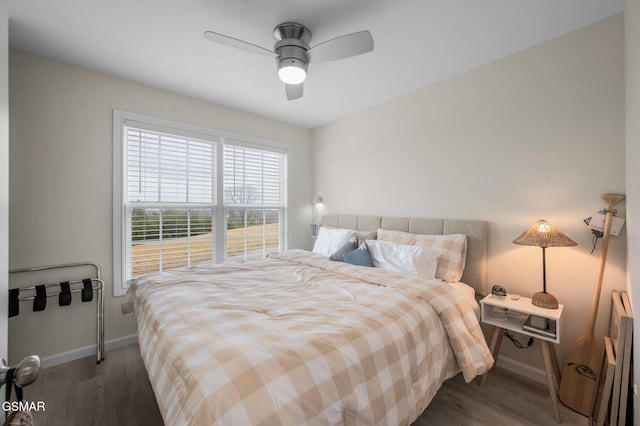 bedroom featuring ceiling fan and dark hardwood / wood-style floors