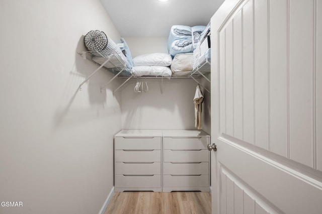 walk in closet featuring light hardwood / wood-style flooring