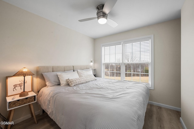 bedroom with ceiling fan and dark wood-type flooring