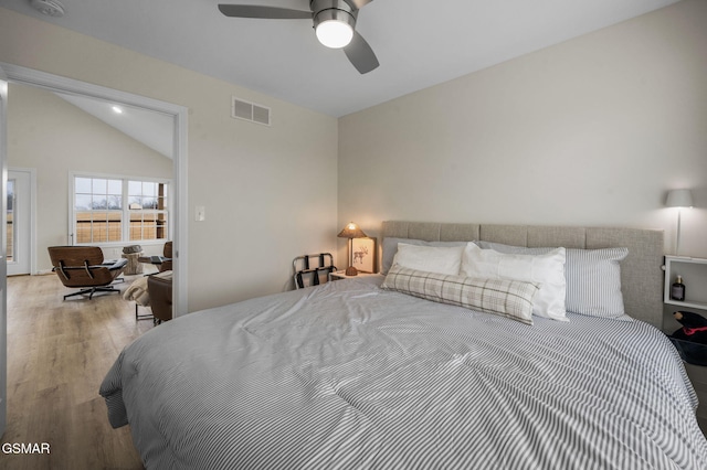 bedroom featuring ceiling fan, light hardwood / wood-style flooring, and vaulted ceiling