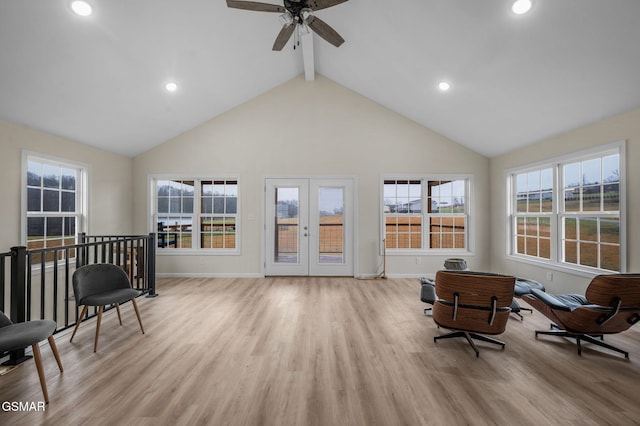 living area with french doors, high vaulted ceiling, beamed ceiling, and light hardwood / wood-style floors