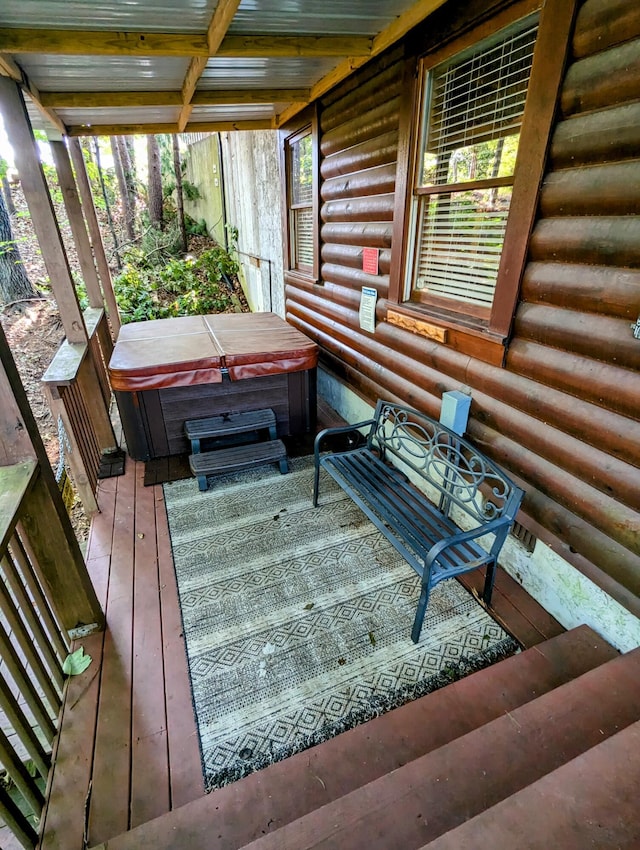 wooden deck featuring a hot tub