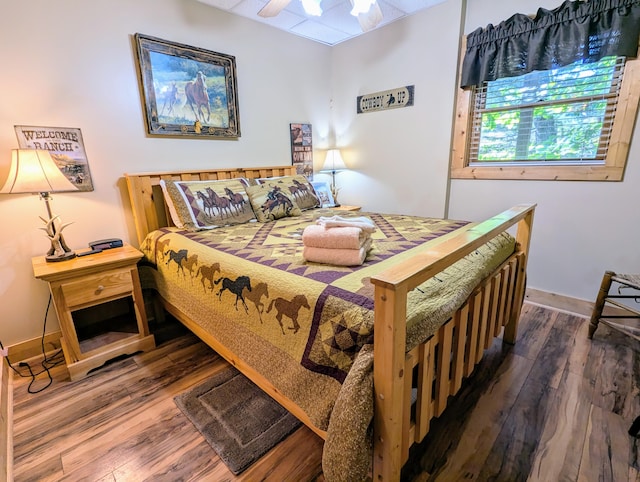 bedroom featuring ceiling fan and dark wood-type flooring