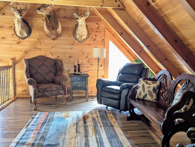 living area featuring lofted ceiling with beams, wooden ceiling, wooden walls, and wood finished floors