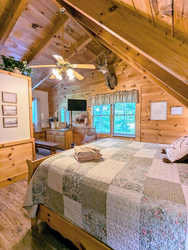 bedroom featuring lofted ceiling with beams, wooden walls, ceiling fan, and wood ceiling