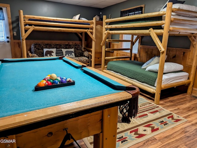 game room featuring a paneled ceiling, pool table, and wood finished floors