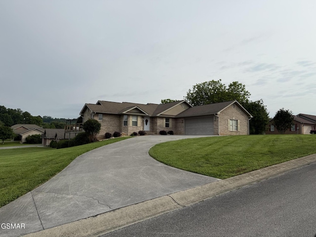 734 Southview Cir, Kodak, TN 37764 - ranch-style house featuring curved driveway, a front lawn, brick siding, and a garage