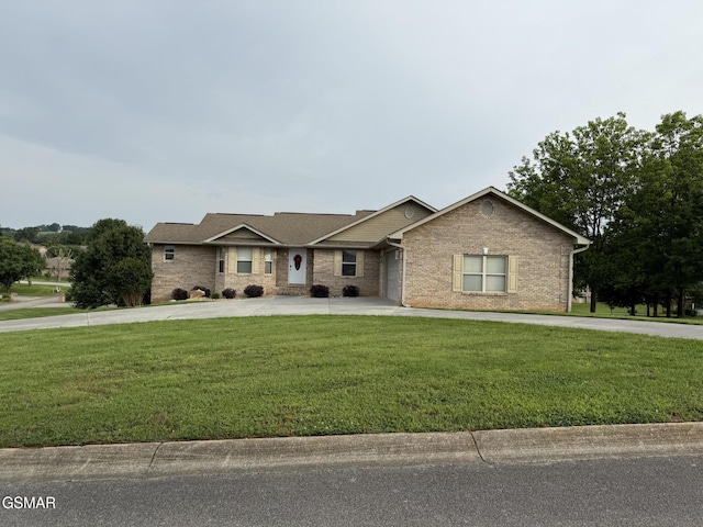 734 Southview Cir, Kodak, TN 37764 - view of front facade featuring curved driveway, a front yard, and brick siding