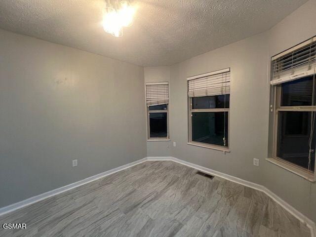 734 Southview Cir, Kodak, TN 37764 - spare room with wood finished floors, a textured ceiling, and baseboards