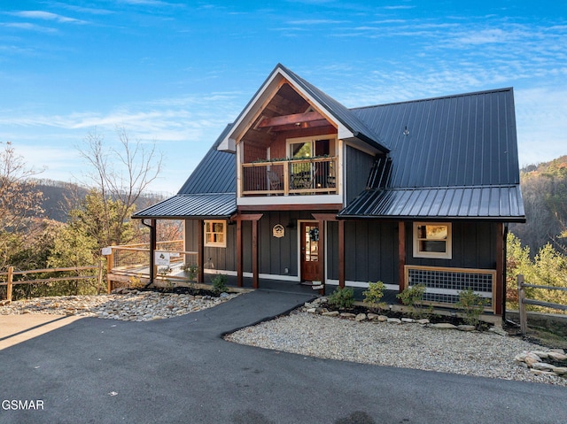 view of front of property featuring covered porch and a balcony