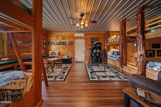 3995 Island View Way, Sevierville, TN 37876 - living room with a wall mounted AC, wooden walls, ceiling fan, hardwood / wood-style flooring, and wood ceiling