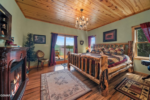 3995 Island View Way, Sevierville, TN 37876 - bedroom with access to outside, a chandelier, wooden ceiling, wood-type flooring, and a lit fireplace