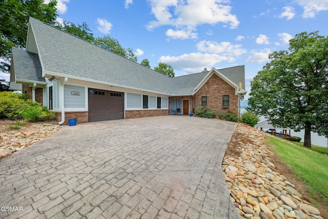 3995 Island View Way, Sevierville, TN 37876 - view of front of house with a garage, roof with shingles, decorative driveway, and stone siding
