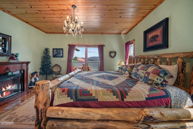 3995 Island View Way, Sevierville, TN 37876 - bedroom featuring wood finished floors, a glass covered fireplace, a chandelier, wooden ceiling, and access to exterior