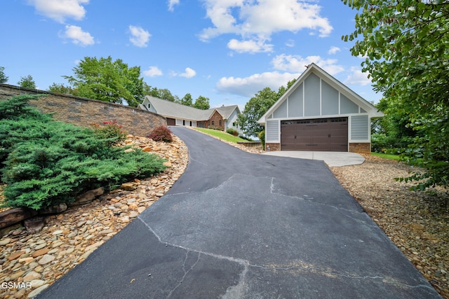 3995 Island View Way, Sevierville, TN 37876 - view of front of home with board and batten siding, a garage, and driveway