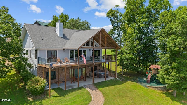 3995 Island View Way, Sevierville, TN 37876 - back of property featuring a patio area, a lawn, a deck, a chimney, and a shingled roof