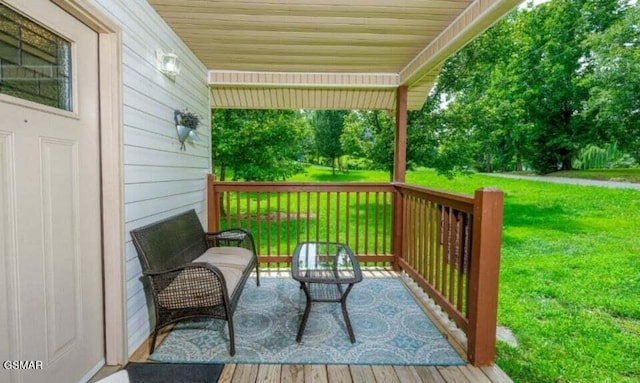 deck featuring a porch and a lawn