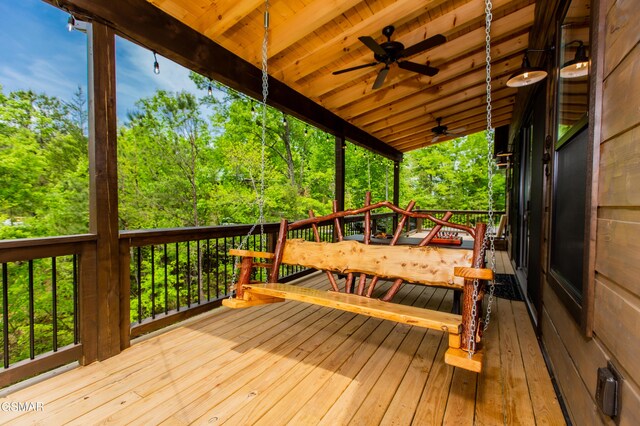 wooden deck with a ceiling fan