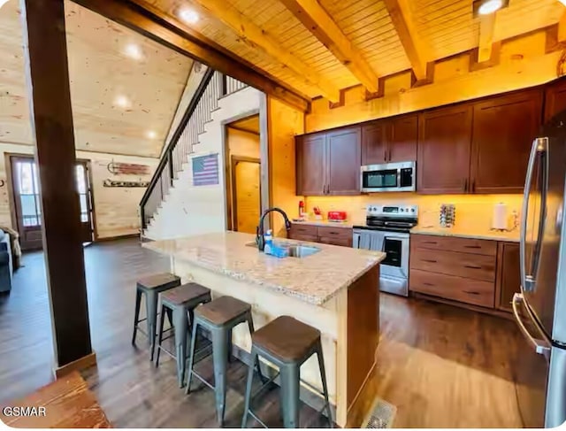 kitchen with wood ceiling, beam ceiling, a sink, stainless steel appliances, and dark wood-type flooring
