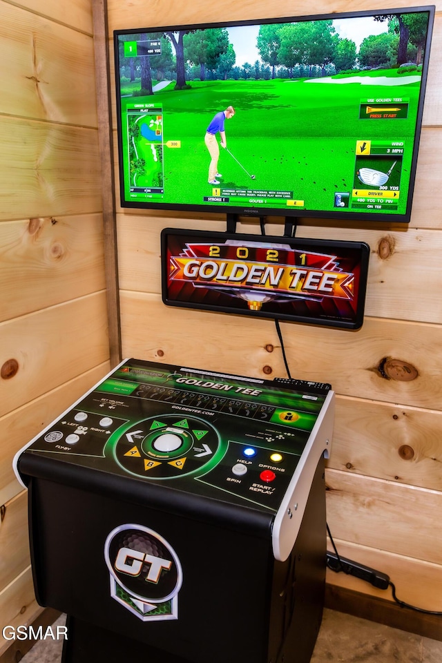 rec room featuring wood walls