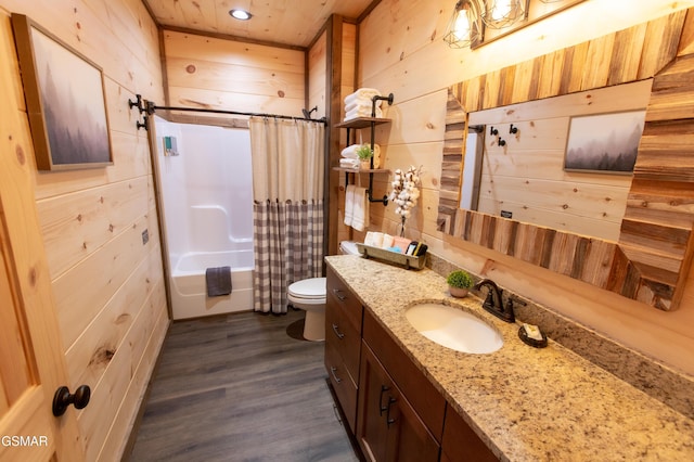 bathroom featuring vanity, wood walls, shower / tub combo with curtain, wood finished floors, and toilet