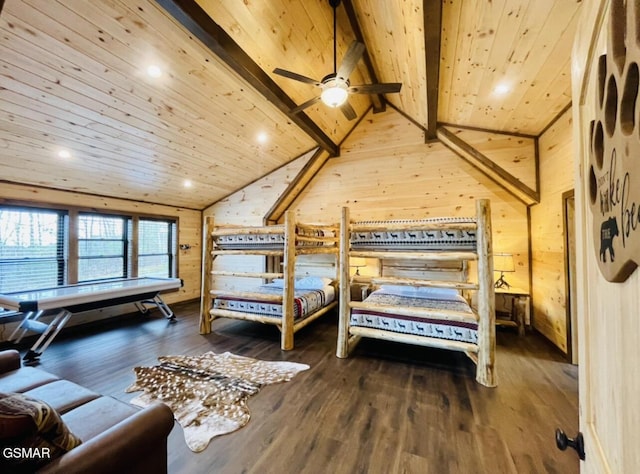 bedroom with wooden walls, lofted ceiling with beams, wood ceiling, and wood finished floors