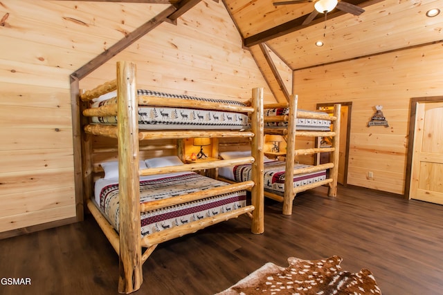 bedroom with wooden walls, wood ceiling, dark wood finished floors, and vaulted ceiling with beams