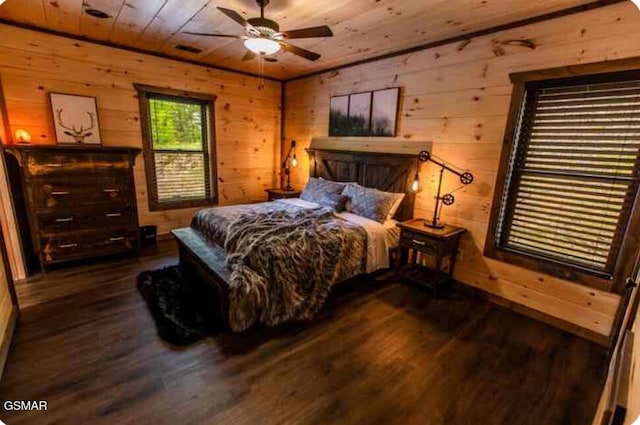 bedroom with wooden walls, wood ceiling, and wood finished floors