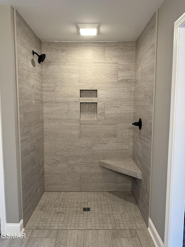 bathroom featuring a tile shower