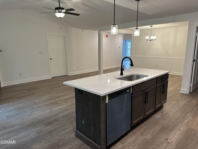 kitchen with pendant lighting, a center island with sink, lofted ceiling, stainless steel dishwasher, and a sink