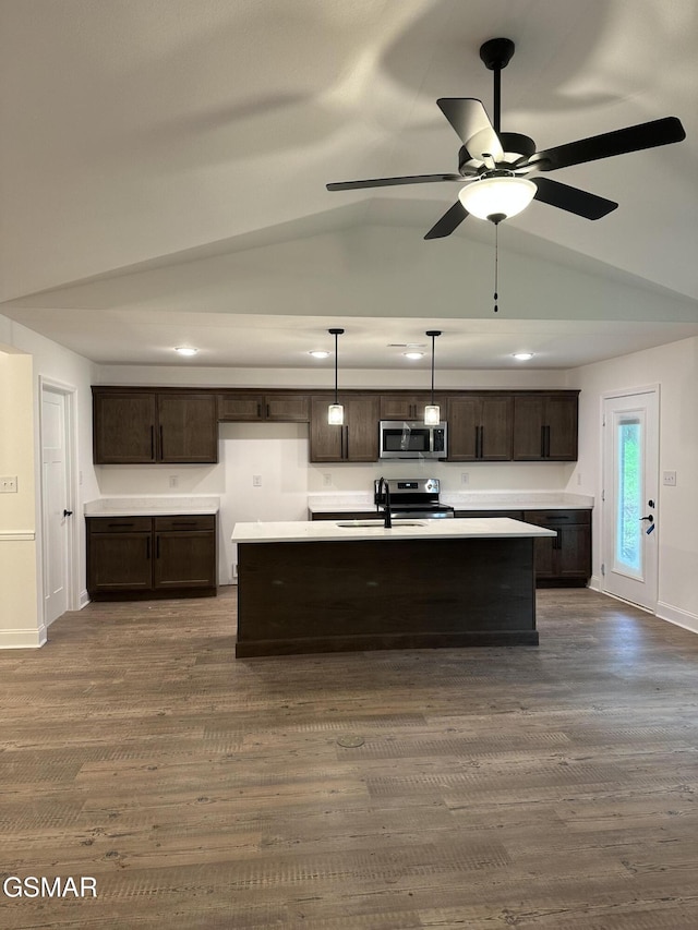 kitchen with pendant lighting, stainless steel appliances, light countertops, a sink, and dark brown cabinets