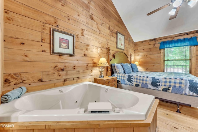 269 Cherokee Path Way, Sevierville, TN 37876 - bathroom with a ceiling fan, wooden walls, and vaulted ceiling