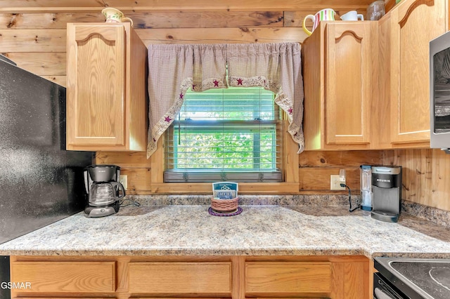 269 Cherokee Path Way, Sevierville, TN 37876 - kitchen with electric range oven, light stone countertops, wood walls, and light brown cabinets