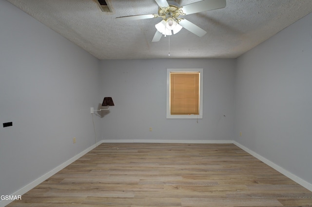 1940 Big Chiefs Skyview Dr, Sevierville, TN 37876 - empty room with visible vents, a textured ceiling, wood finished floors, and ceiling fan